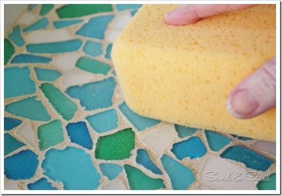 a person is using a sponge to clean the floor