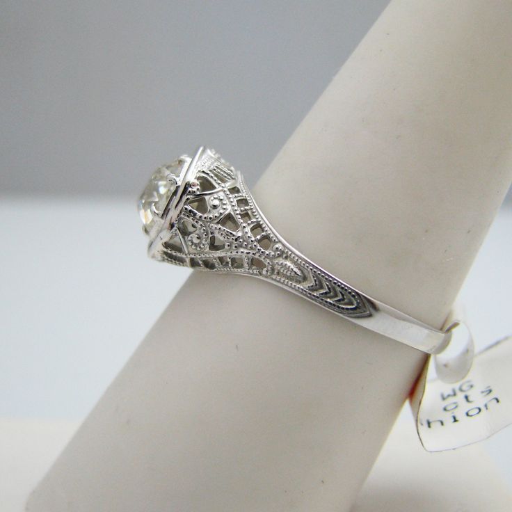 "For sale: (1) g009 Pretty 14k White Gold Diamond Old Mine Cut Engagement Ring PLEASE READ ENTIRE DESCRIPTION BEFORE PURCHASING Pre-owned item. Good condition. Please see pictures for details. Sold as is, as seen on pictures. This ring contains one diamond (round cut). It is stamped. Specifics: 14k White gold Diamonds: 0.85CT/TCW Size: 7.5 (U.S.) Width: 9 mm Total Weight: 1.7 grams Please be 100% sure of your purchase before buying, as we do not offer refunds. We are more than happy to provide a Classic 14k Stamped Wedding Diamond Ring, Vintage Vvs Clarity Jewelry For Formal Occasions, Classic 14k Stamped Diamond Wedding Ring, Exquisite Diamond Cut Filigree Ring For Formal Occasions, Formal Diamond Filigree Ring With Diamond Cut, Diamond White Emerald Cut Jewelry For Formal Events, Emerald Cut Diamond White Jewelry For Formal Occasions, Emerald Cut Diamond White Jewelry For Formal Events, Formal Diamond White Emerald Cut Jewelry