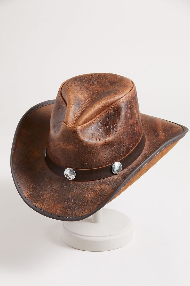 Honor your inner cowboy or cowgirl with the Renegade leather hat. From the handcrafted pinch crown to the 3" vinyl edged shapeable brim, this cowhide leather hat crowns you with good looking western flair. A matching hatband with buffalo conchos adds the perfect finish to a year round hat you can shape to your liking for just the right look, while the adjustable sweatband gives you a custom fit. Western Style Leather Hat With Short Brim, Western Leather Brimmed Hat, Western Style Leather Brimmed Hat, Leather Western Hat With Flat Brim, Brown Leather Fedora For Rodeo, Western Style Leather Hat With Flat Brim, Leather Fedora For Rodeo With Short Brim, Rugged Leather Hats For Western-themed Events, Leather Fedora Hats For Rodeo