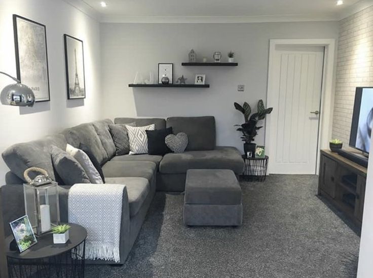 a living room filled with furniture and a flat screen tv on top of a wall