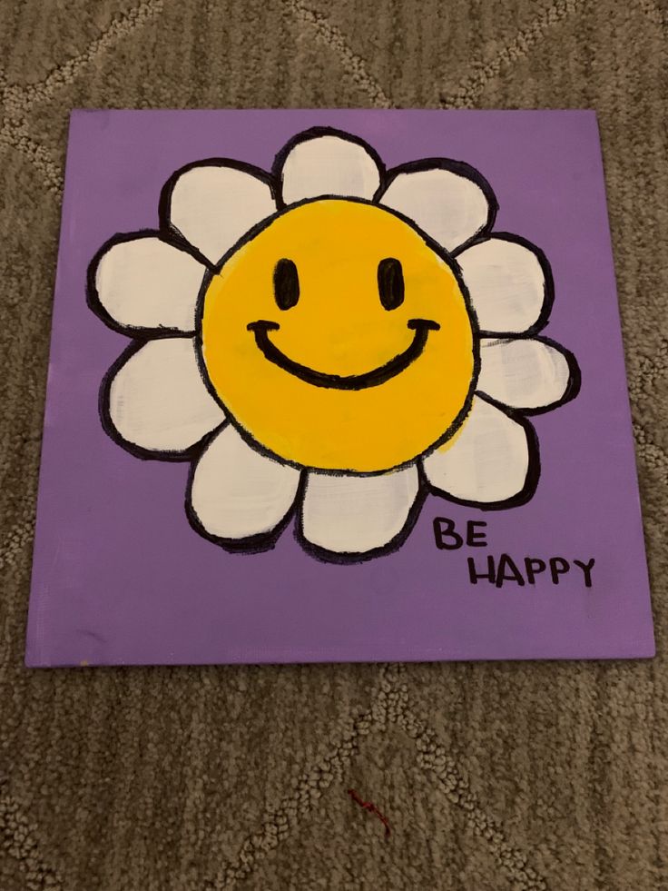 a purple and white square with a smiling flower on it that says, be happy