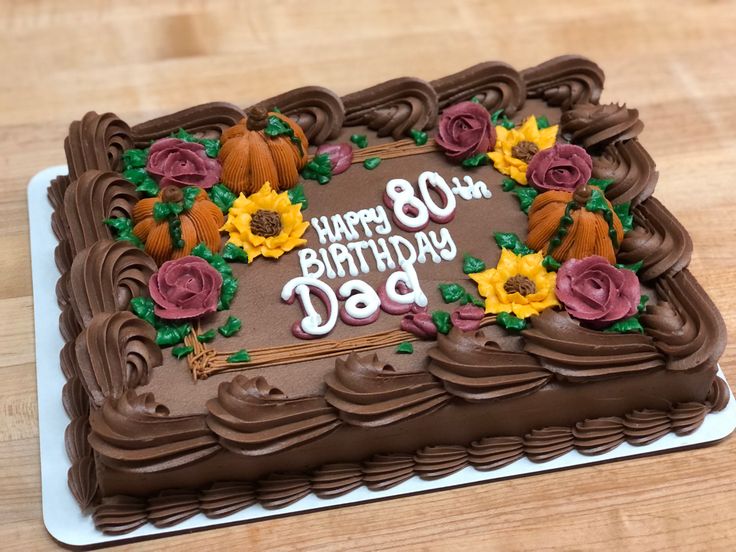 a birthday cake with chocolate frosting and sunflowers on the top that says happy 80th day