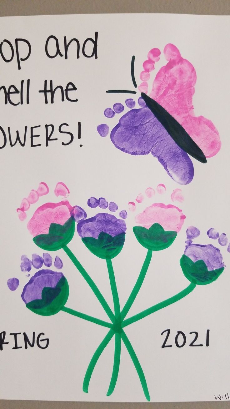 a handprinted sign with flowers and a butterfly on it that says stop and smell the flowers