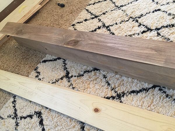 a wooden bench sitting on top of a rug