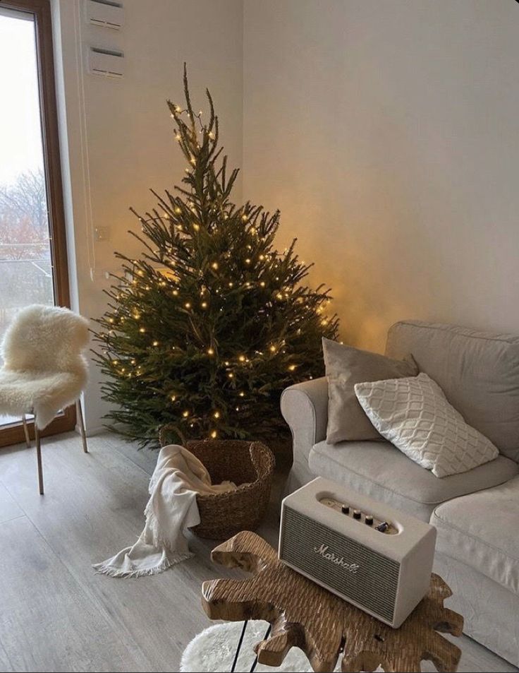 a living room with a christmas tree in the corner and an animal rug on the floor