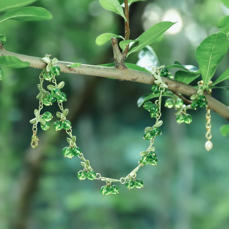 Handcrafted from 18 karat gold, our Emerald Berry Necklace is the perfect combination of luxury and elegance. This exclusive necklace features an intricate design and a delicate berry motif that exude sophistication. The perfect accessory for any look, the Emerald Berry Necklace is truly luxurious and exclusive. DETAILS Plating: 18K Gold Materials: 18K Gold on brass, Agate Measurements: Length:   13.39"(34cm)  + Extender: 2.36"(6cm) Weight:   34.32 g Nature-inspired Green Necklaces With Natural Stones, Green Faceted Fine Jewelry Necklace, Luxury Nature-inspired Gemstone Bead Necklaces, Multicolor Nature-inspired Gemstone Bead Necklaces, Nature-inspired Multicolor Gemstone Beads Necklace, Wheel Of Fortune Tarot, Demon Eyes, Diamond Star Necklace, Star And Moon Necklace