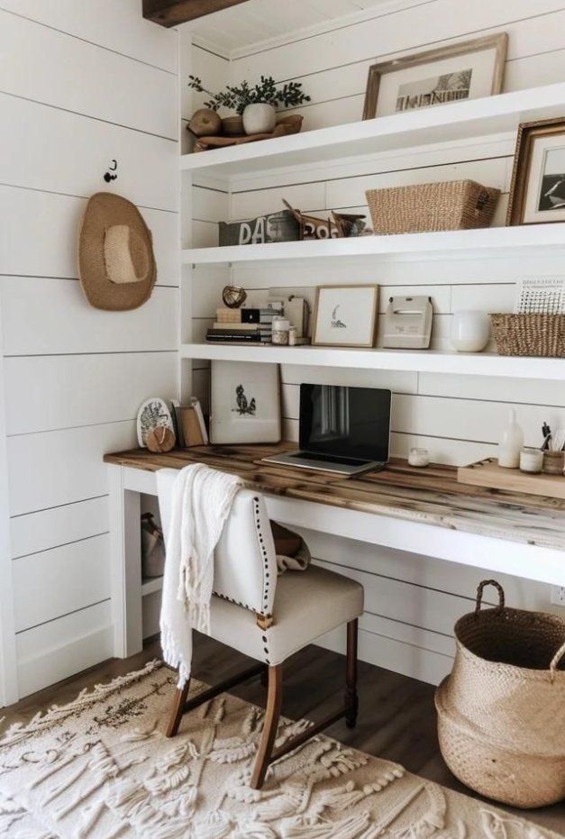 a white desk and chair in a room with wooden shelves on the wall above it