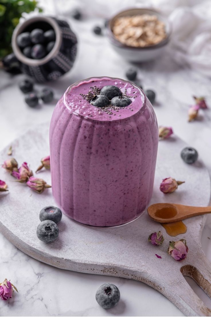 a blueberry smoothie in a bowl on a marble platter