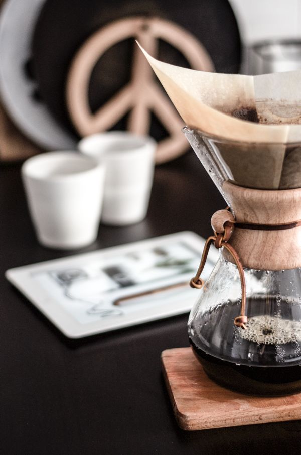 a coffee pot sitting on top of a wooden table