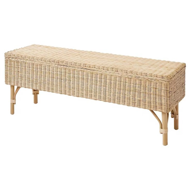 a wicker bench sitting on top of a white floor