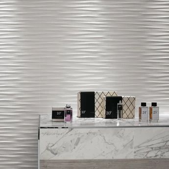 a marble counter top in front of a white wall with wavy lines on the walls