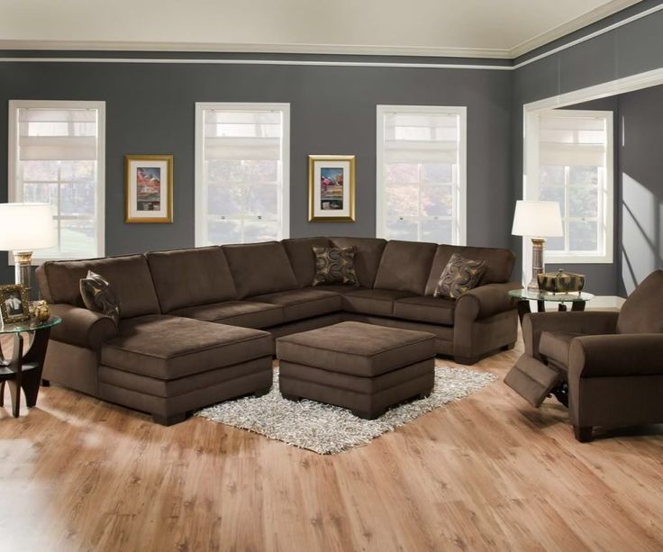 a living room filled with lots of furniture on top of a hard wood floored floor