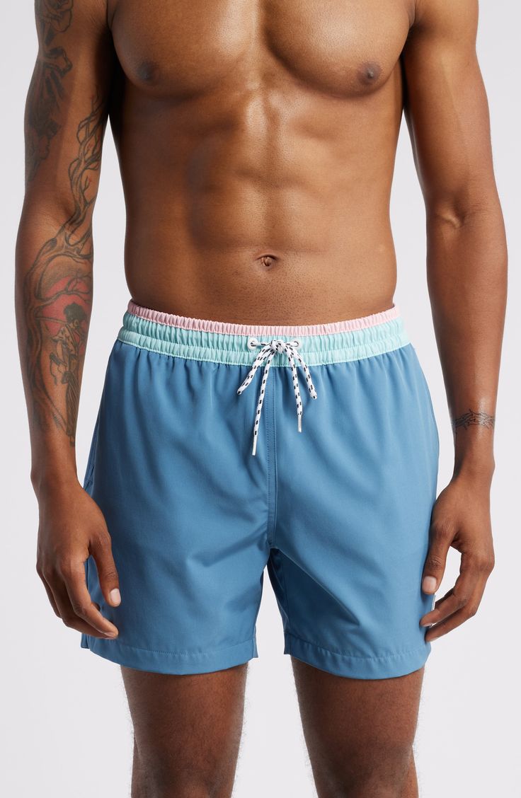 These classic swim trunks are made with quick-drying four-way-stretch fabric and built-in mesh compression shorts for comfort wherever the waves take you. 5 1/2" inseam; 23" leg opening; 11 1/2" front rise; 14 1/2" back rise (size Medium) Elastic/drawstring waist Side-seam pockets with mesh lining; back zip pocket Built-in mesh compression shorts UPF 50+ sun protection Four-way-stretch fabric 92% polyester, 8% spandex Machine wash, tumble dry Imported Blue Swim Trunks With Built-in Shorts For Water Sports, Training Swimwear With Built-in Shorts, Blue Swimwear With Built-in Shorts For Sports, Blue Athletic Shorts With Built-in Shorts For Water Sports, Blue Swim Trunks With Elastic Waistband For Poolside, Moisture-wicking Blue Swimwear For Beach Season, Blue Moisture-wicking Swimwear For Beach Season, Blue Moisture-wicking Swimwear, Blue Swim Trunks With Built-in Shorts