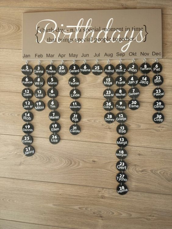 a wooden table topped with lots of black and white magnets on it's side