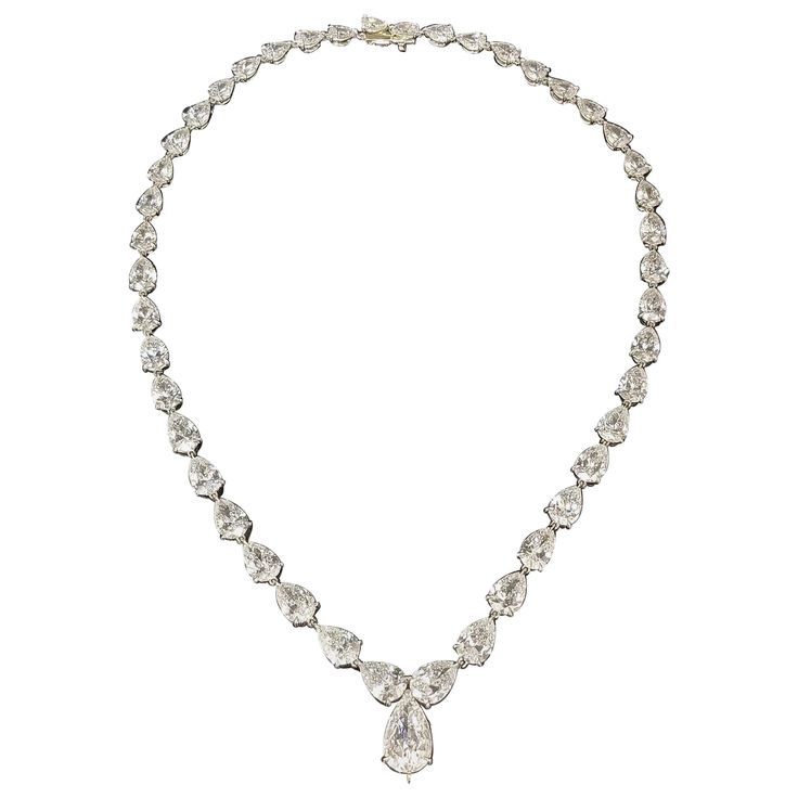 Scarselli features this enchanting 31.27 carats pear cut diamond tennis necklace in Platinum. Each diamond is GIA certified total of 45 pear-cut diamonds from 0.35ct to 2.08ct the biggest, D-E-F color (One diamond graded G) clarity VVS-SI. This exquisite necklace sparkles on its own when worn or can be enhanced with a pendant of your choice attaching it to the hidden hook that can securely support as the picture shown, an outstanding Scarselli 26ct Fancy Yellow Pear shape (pendant is not include Pear Shaped Diamond Necklace, Drop Necklaces, Pear Shaped Pendant, The Bling Ring, Pearl Drop Necklace, Diamond Tennis Necklace, Pear Cut Diamond, Diamond Necklaces, Vintage Necklaces