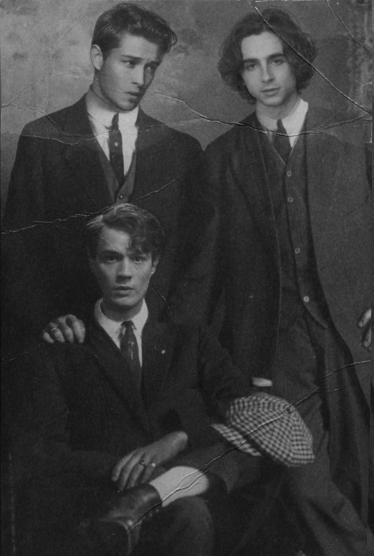 an old photo of three men in suits