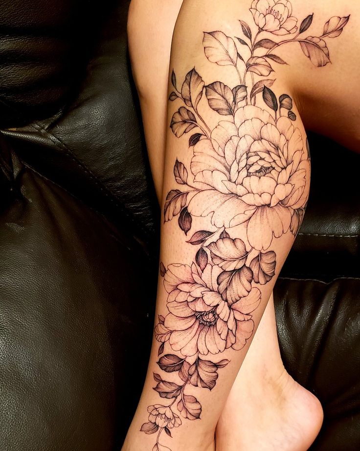 a woman's leg with flowers on it