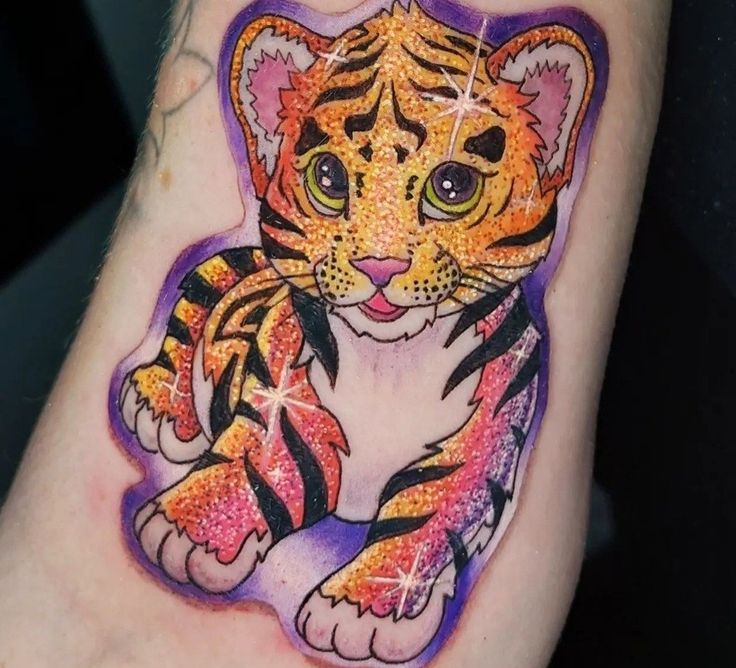 a small tiger tattoo on the left arm and leg, with stars in it's eyes