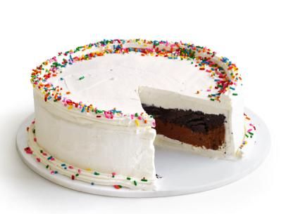 a white cake with one slice missing from it