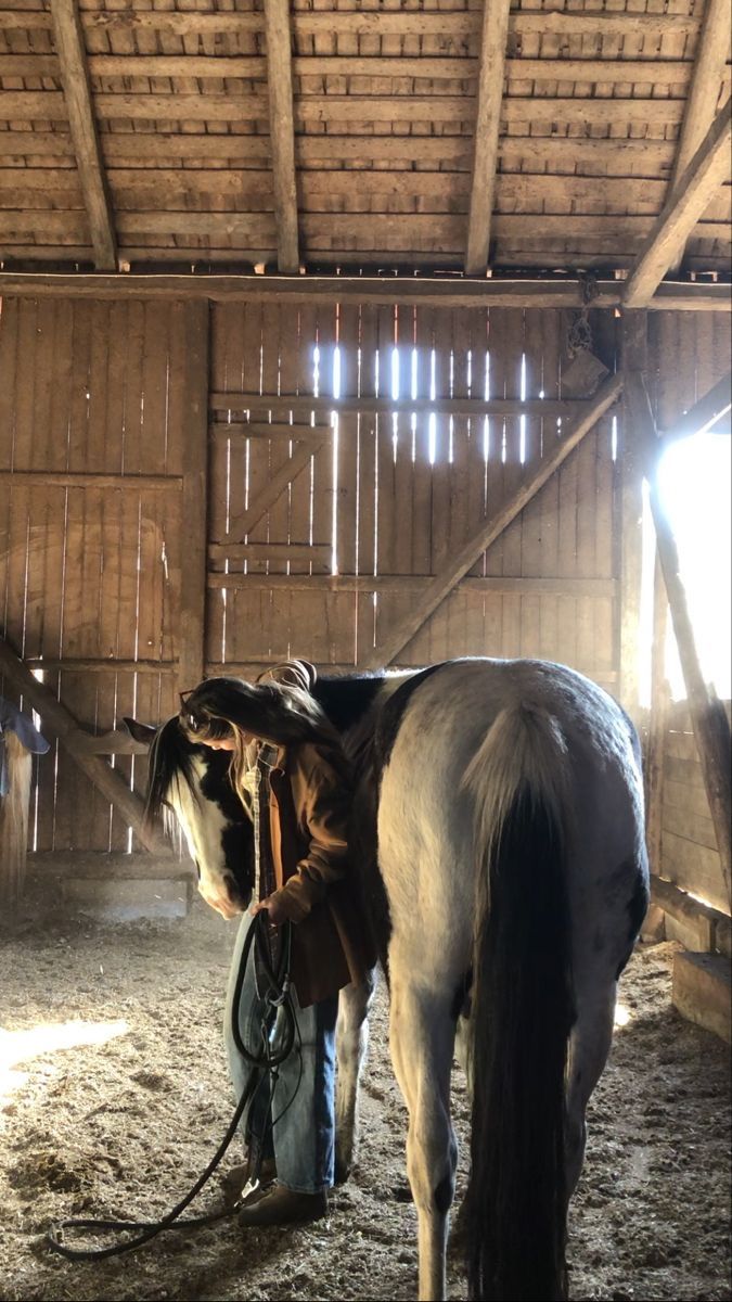 a horse is tied up in a barn