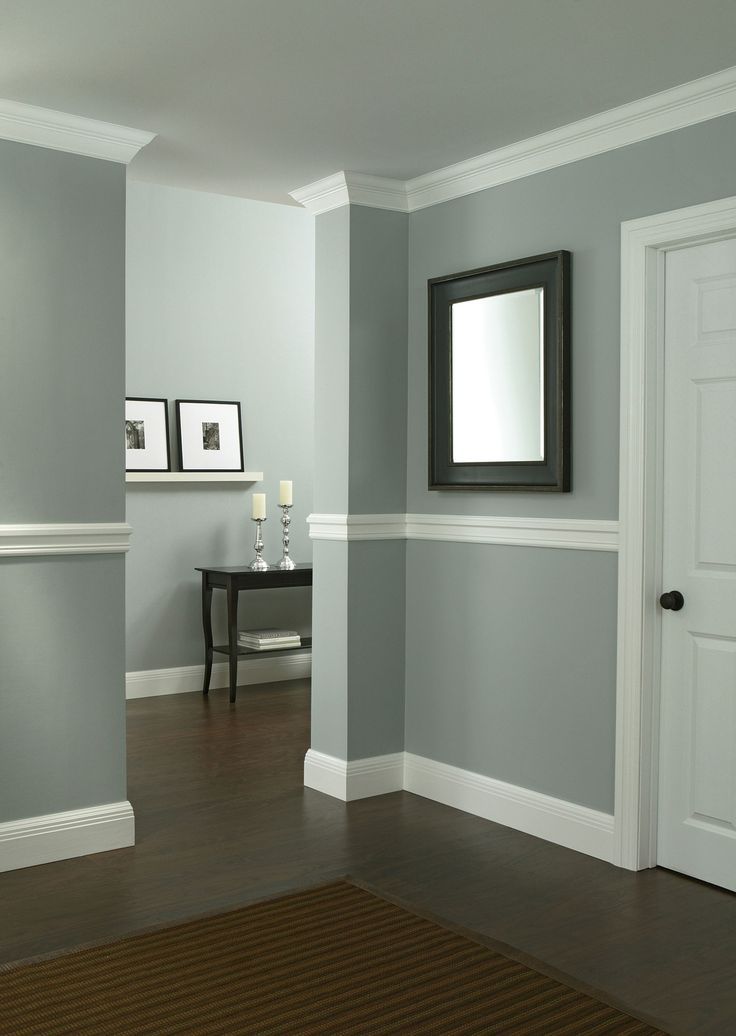 a living room with gray walls and white trim