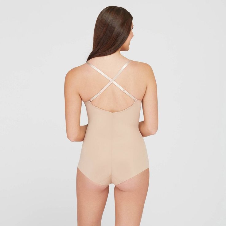 This versatile bodysuit is the ultimate solution for low-back dresses! The flawless-finish fabric is lightweight, cling-free, and offers 360 degrees of comfortable, single-layer shaping for a sleek, all-over feel. And, best of all? The innovative design features lightly padded, fit-flexible wireless cups and adjustable, convertible straps for a variety of styling options Sculpting Full Coverage Bodysuit With Built-in Bra, Second-skin Camisole Bodysuit With Built-in Bra, Second-skin Shapewear With Built-in Bra And Full Coverage, Stretch Backless Bodysuit With Built-in Bra, Shapewear Leotard With Built-in Bra, Second-skin Bodysuit With Built-in Bra And Low Back, Backless Nylon Leotard With Built-in Bra, Fitted Camisole Leotard With Built-in Bra, Summer Shaping Backless Bodysuit