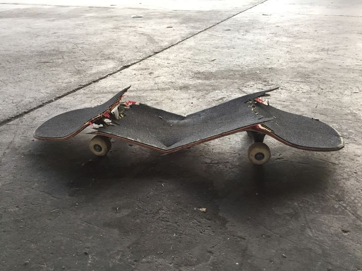 an upside down skateboard sitting on the ground