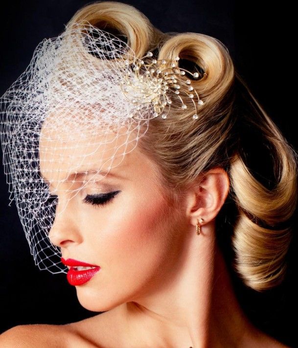 a woman wearing a veil and red lipstick