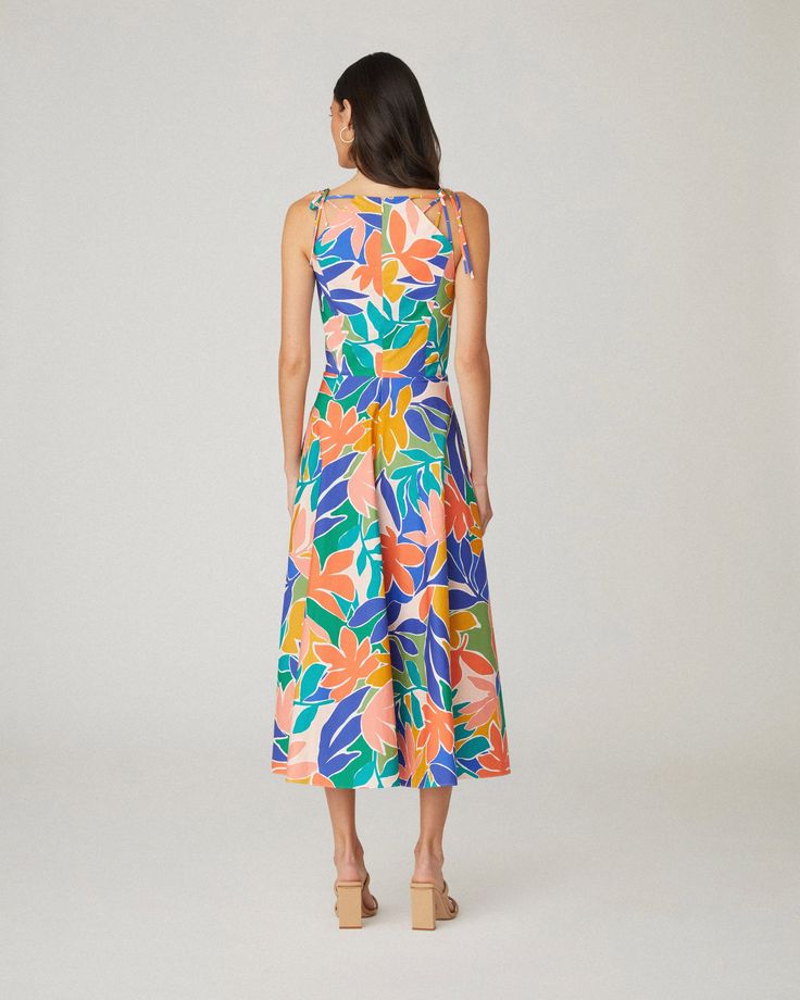 Floral printed cotton sleeveless midi sundress. This style features shoulder ties, a curved neckline, a fitted bodice with interior boning, and a full A-line midi skirt with side seam pockets. Bodice lined, skirt unlined. Hidden back zipper. 97% Cotton, 3% Spandex. Dry clean only. Color: Sunburst Multi Unlined A-line Midi Dress For Summer, Vacation A-line Midi Dress With Tie Back, Spring A-line Midi Dress With Tie Straps, Casual A-line Midi Dress With Tie Straps, Tropical Print Midi Sundress For Day Out, Summer A-line Maxi Dress With Tie Waist, Sleeveless Multicolor Tropical Print Midi Dress, Sleeveless Multicolor Midi Dress With Tropical Print, Multicolor Midi Length Dress With Tie Straps