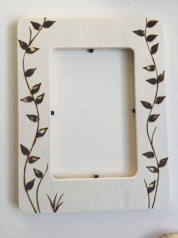 a white frame with black leaves on it