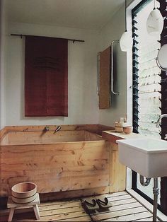 a bathroom with a wooden tub and sink