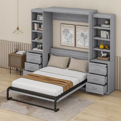 a bed sitting under a book shelf next to a wall mounted cabinet with drawers on each side