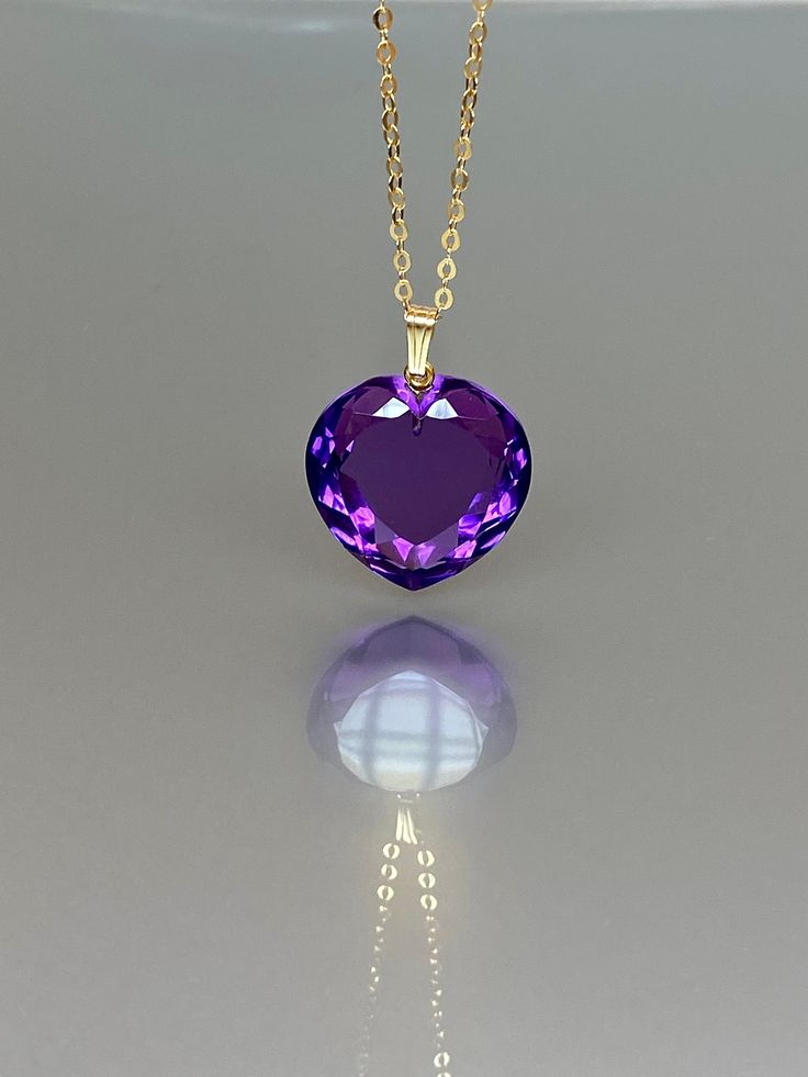 Absolutely stunning amethyst heart pendant necklace, sparkling with enchantment. The flawlessly faceted heart-shaped pendant showcases a beautiful, vivid, clear deep purple color that adds a remarkable depth to the stone, reflecting light in a captivating manner. The amethyst's powerful and yet somehow romantic aura is elegantly captured in this design. The pendant is gracefully strung on your choice of a sterling silver, 14K gold-filled, or rose gold-filled chain, offering versatility for layer Luxury Purple Jewelry Gift, Fine Jewelry Heart-shaped Amethyst, Heart Shaped Amethyst Jewelry For Wedding, Purple Heart-shaped Amethyst Necklaces, Purple Amethyst Heart Necklaces, Purple Heart Cut Necklace For Valentine's Day, Purple Heart Jewelry For Formal Occasions, Heart-shaped Amethyst Wedding Jewelry, Purple Amethyst Heart Necklace