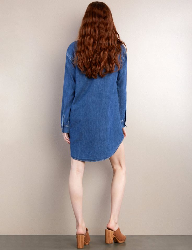 We LOVE oversized anything, so we designed the oversized Denim Shirtdress to be one of your go-to's this—and every—season. Super-soft denim with button-front and front pockets make it cuter-than-cute! The model is 5'9" wearing size small Fabric: 100% Cotton Length: 35 1/2" from shoulder Relaxed Fit Chambray Denim Dress In Medium Wash, Relaxed Fit Chambray Denim Dress, Oversized Button-up Blue Shirt Dress, Oversized Blue Button-up Shirt Dress, Oversized Medium Wash Denim Top With Button Closure, Medium Wash Long Sleeve Shirt Dress With Pockets, Casual Dark Wash Denim Dress With Buttoned Pockets, Relaxed Fit Denim Dress With Pockets In Denim Blue, Cotton Denim Button-up Dress For Daywear