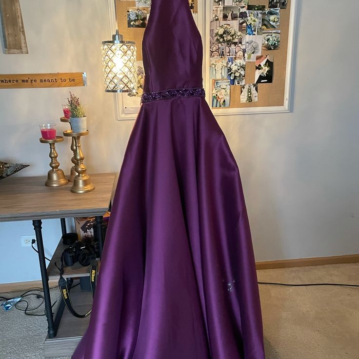 A Long Purple Dress With A Beautiful Opened Back! Elegant Purple A-line Gown, Elegant A-line Homecoming Gown, Purple Satin Formal Dress, Purple Floor-length Dress For Homecoming, Purple Dress With Fitted Bodice For Homecoming, Purple A-line Formal Gown, Purple A-line Gown For Formal Occasions, Formal Purple A-line Gown, Purple A-line Evening Dress For Formal Occasions