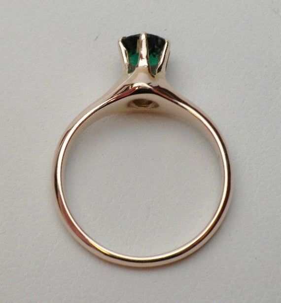 This is a 1940s-1950s classic! This is a six prong solitaire ring that has a 5.50 mm round synthetic (man made) green stone for the birth month of May. The stone has a fancy faceted top, similar to a rose cut on the top but with a pavilion like a modern cut round stone. There are some abrasions around the girdle, but the ring looks brand new other than that! The ring is stamped 10 kt and weighs 2.9 grams. Ring is sie 6.z Heirloom Emerald Cut Solitaire Birthstone Ring, Heirloom Style Solitaire Rings For May Birthstone, Modern Green Rings With Prong Setting, Elegant Emerald Ring With Bezel Setting, Classic Polished Emerald Ring For Wedding, Classic Polished Emerald Wedding Ring, Timeless Green Round Band Jewelry, Elegant Green Birthstone Ring With Bezel Setting, Elegant Green Round Band Ring