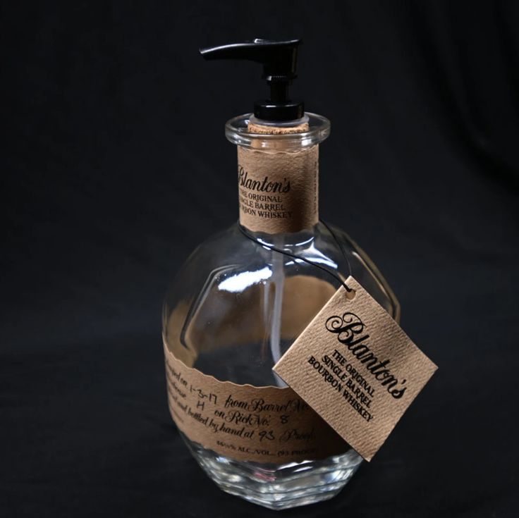 a bottle of soap with a label on it sitting in front of a black background