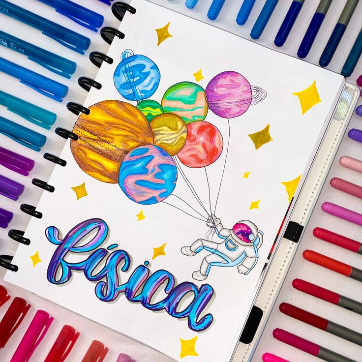 an open notebook with colored crayons next to it and the words fiesta written in spanish