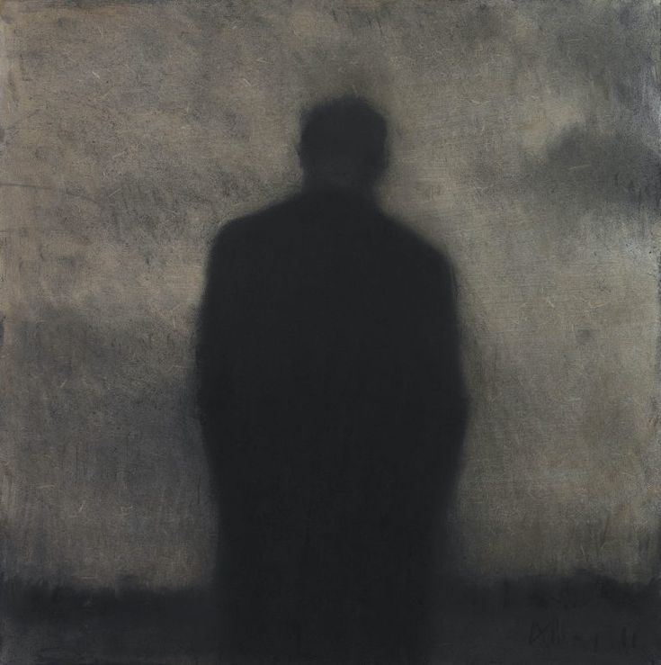 the shadow of a man standing in front of a wall