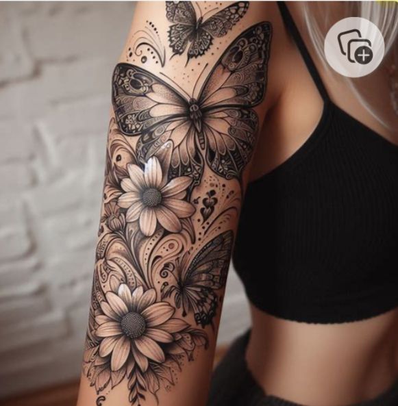 a woman's arm with flowers and butterflies on it