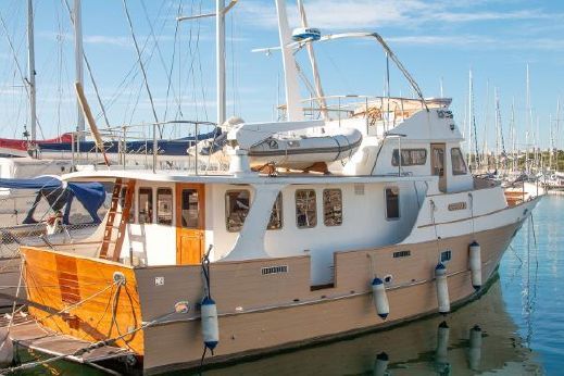 a boat docked at a dock with other boats in the water