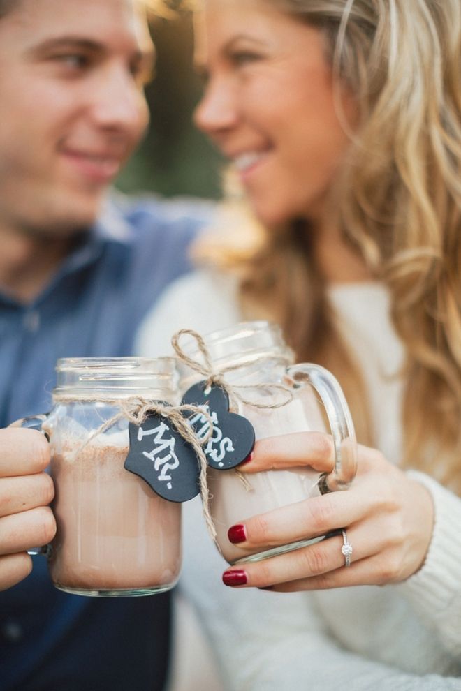 a man and woman holding up mason jars with hearts on them that say mr and mrs