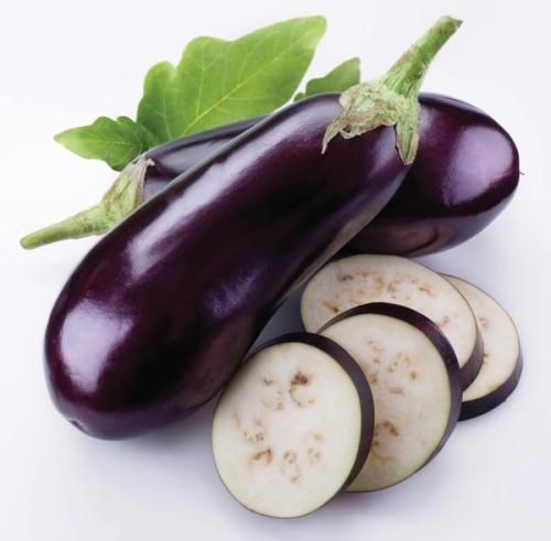 an eggplant and four slices on a white background