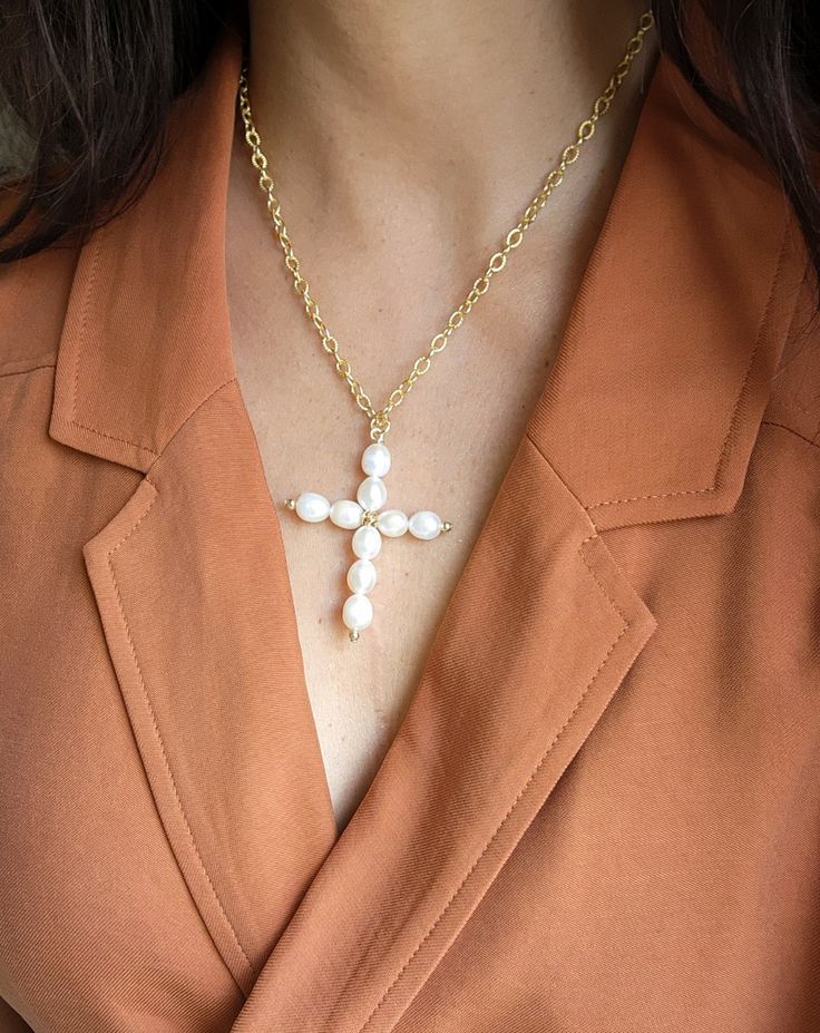 A delicate symbol with subtle shine, the Cross Pendant Necklace in Freshwater Pearls is a meaningful reminder of what matters to you most. Celebrating all forms of beauty. Wear it as a stand-alone piece or pair it with any of our necllaces to create an statement look. Details: A+ Quality pearls carefully hand selected. Pendant: Hand forged Secured with a 14k gold clasp. Adjustable length up to 24" Sustainable and natural materials Ships with eco-friendly package, brand charm and jewelry bag Spiritual Cross-shaped Pearl Chain Jewelry, Elegant White Cross Necklace With Pearl Pendant, Cross Pendant Pearl Chain Necklace As Gift, Elegant Handmade Cross Pendant Necklace, Elegant Pearl Pendant Cross Necklace As Gift, Elegant White Cross Necklace With Adjustable Chain, White Cross Necklace For Everyday, Spiritual Cross Jewelry With Pearl Charm, Elegant Hypoallergenic Cross Pendant Jewelry