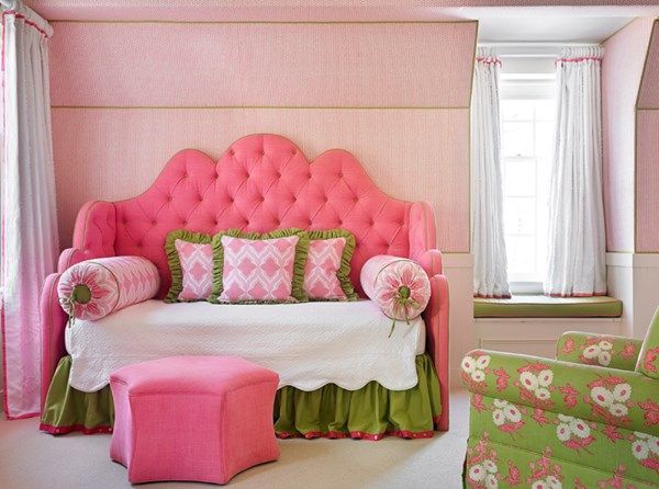 a bedroom with pink and green furniture in it