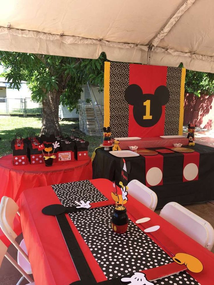 the table is set up with mickey mouse decorations