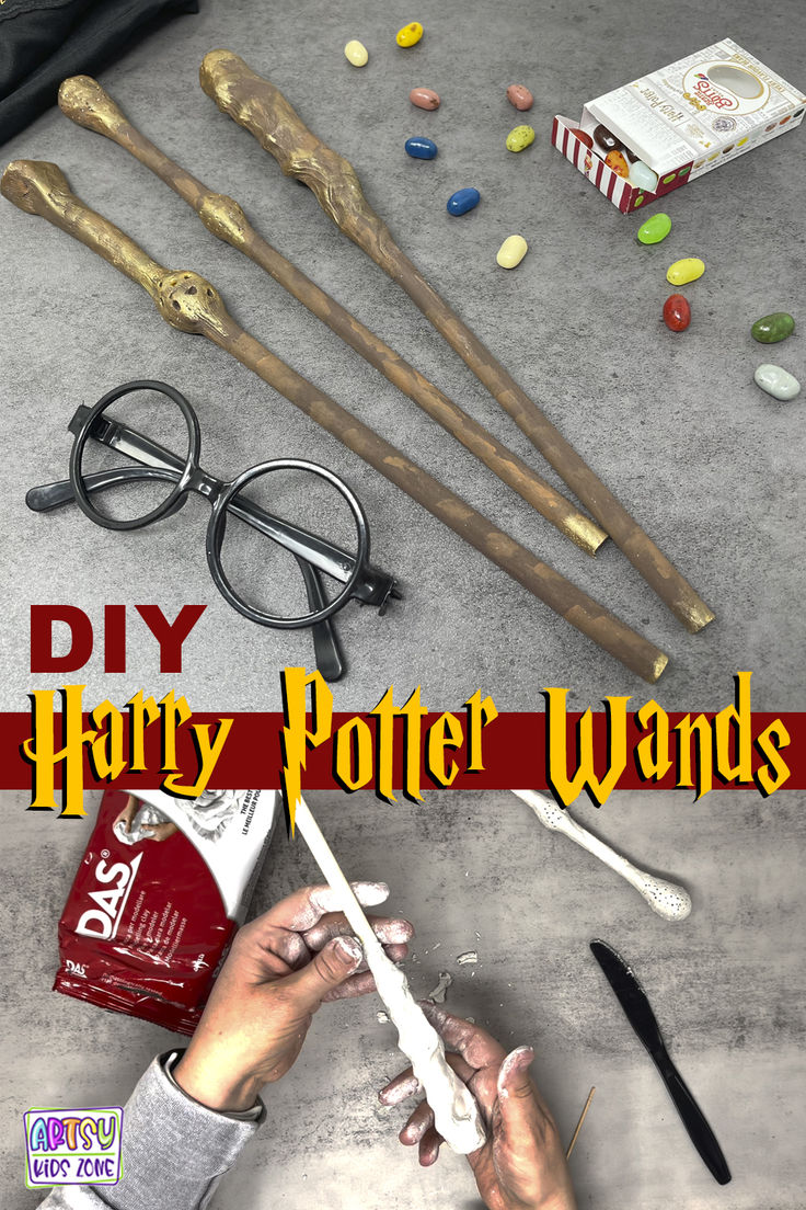 some harry potter wands are laying on the floor with candy and other items around them