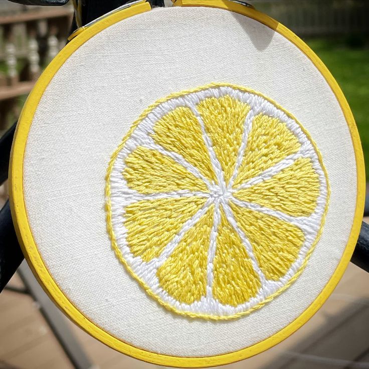 a close up of a yellow and white embroidery