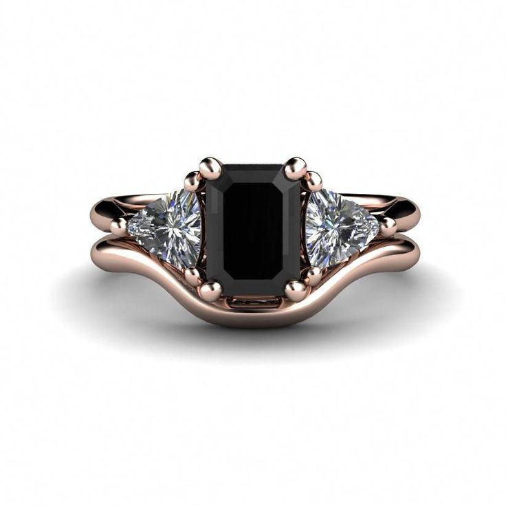 a black diamond ring with three diamonds on it