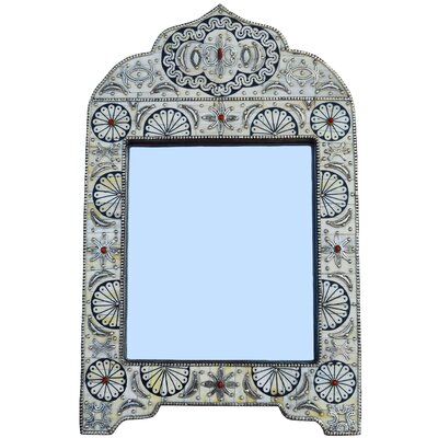 an ornate mirror is shown against a white background